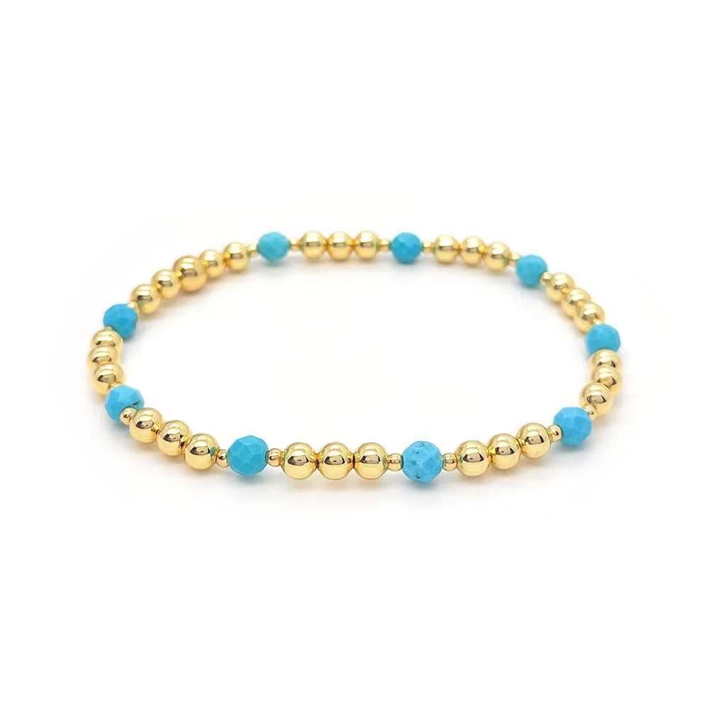 Bracelet vintage avec des perles turquoises et une croix en pendentif