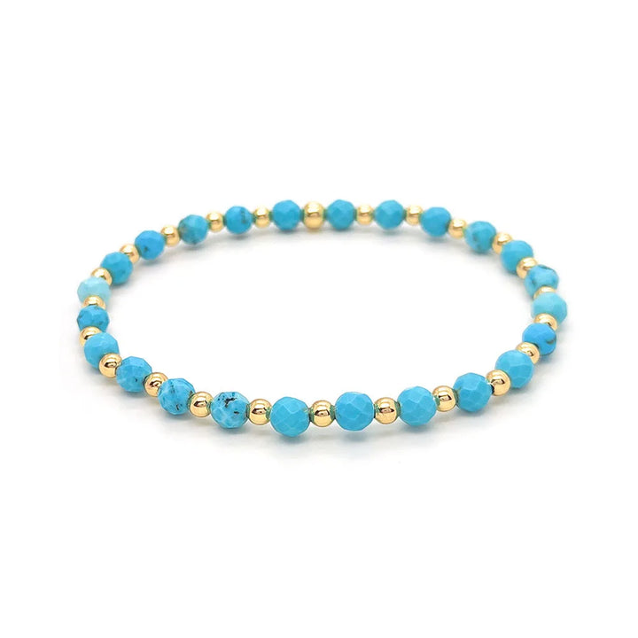 Bracelet vintage avec des perles turquoises et une croix en pendentif