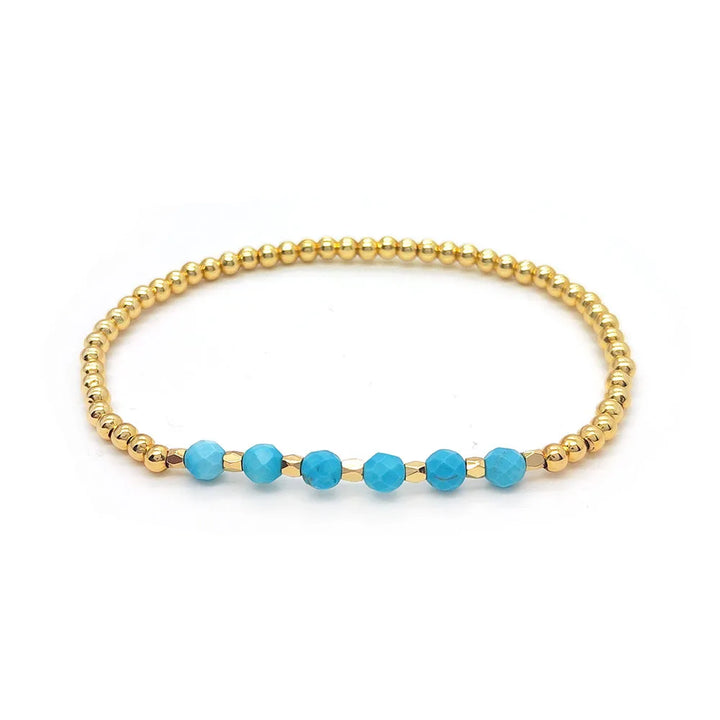Bracelet vintage avec des perles turquoises et une croix en pendentif