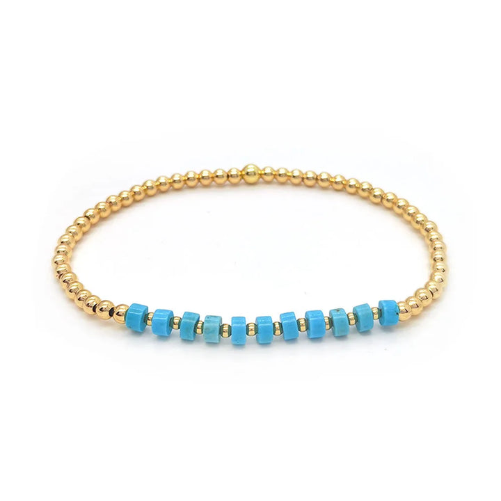 Bracelet vintage avec des perles turquoises et une croix en pendentif